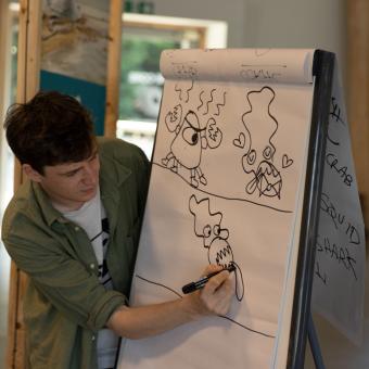 Artist drawing on a board during Illustration Workshop